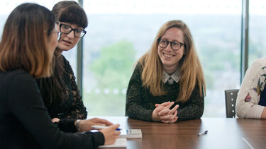 Staff in discussion with students 