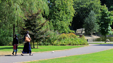 Two women walking in Western Park, Sheffield