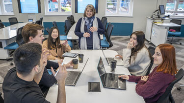 law students sat around the table with teacher