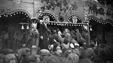 Fairgoers flocking into a sideshow in the 1940s