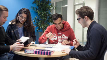 A group of Economics undergraduate students sitting at a table studying. 
