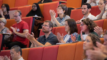 Audience applauding in auditorium at Insigneo Showcase 2022