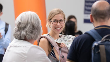 Dr Erica Montefiori and people networking at Insigneo Showcase 2022