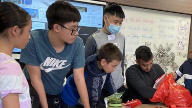 Teacher Sagar with students in STEM class