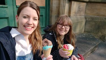 Two young women smiling with ice cream in their hands 