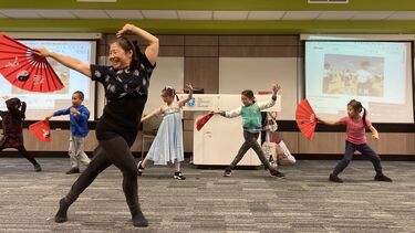 Teacher Shan leading performance of fan dancing