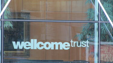 The image, titled "Wellcome Trust" by Howard Lake is licensed under CC BY-SA 2.0 license (where author crediting is required). The image shows the Wellcome Trust logo embossed on a window of London HQ. Image sourced from: https://wordpress.org/openverse/image/b18c7a0c-e536-432b-9860-cdca1c434301