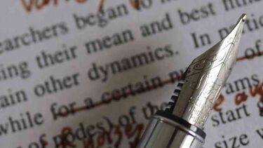 CC-BY image of a sheet of typed text marked with a red pen, pen laid on the paper. Image is CC-BY sourced from https://flic.kr/p/ex3XEk