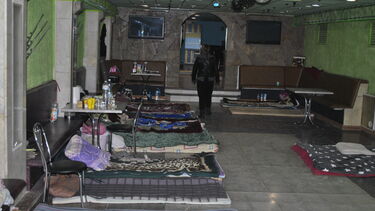 A student nightclub that was being used as a temporary air raid shelter with mattresses on each side of the room