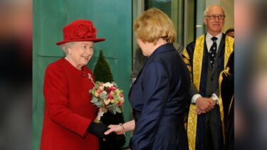 Her Majesty shaking the hand of Professor Dame Pamela Shaw, Director of SITraN