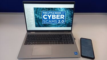 An open laptop and phone next to it