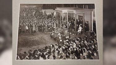 Her Majesty watching the masque from inside a glass pavilion.