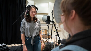 Women singer recording into mic