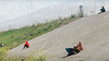 Refugees on sand dune near Calais