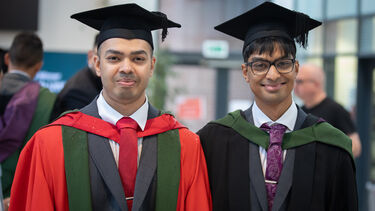 Nabhan and Mahdi stood together wearing graduation gowns
