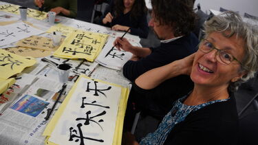Student with her calligraphy work
