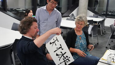 Student presents his calligraphy work
