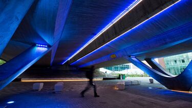 One person walking under the concourse