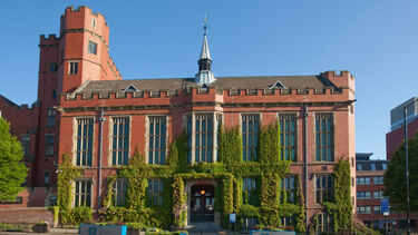 Exterior shot of red brick building against blue sky