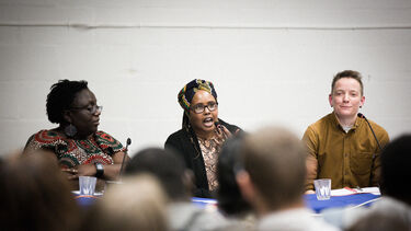 Image of three people on a panel debating a topic