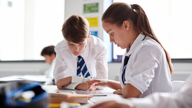 Two students working on a tablet
