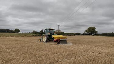 A photo showing a tractor spreading basalt on our field site at Harpenden