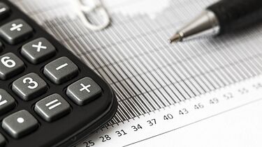 Image of a calculator and pen