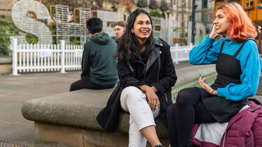 Two students sat outside talking