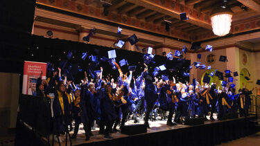 Children graduating from the South Yorkshire Children's University throw their hats in the air