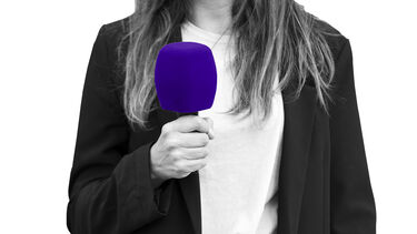 Female journalist holding a microphone
