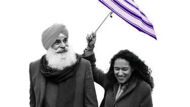 man and woman sharing umbrella