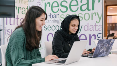 2 Students working at laptops