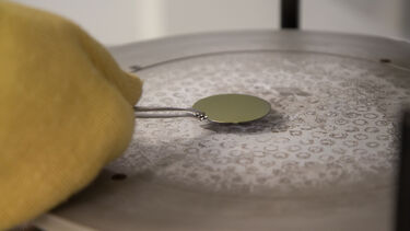 A close up shot of a sensor being handled in a laboratory