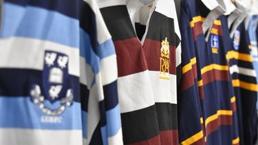 A row of rugby jerseys hung up.