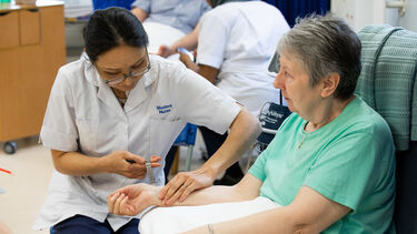 Nurse taking a patient's pulse