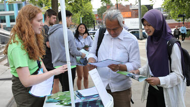 A student and parent talking to a general student ambassador.