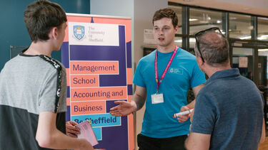 A prospective student and parent talking to a student ambassador.