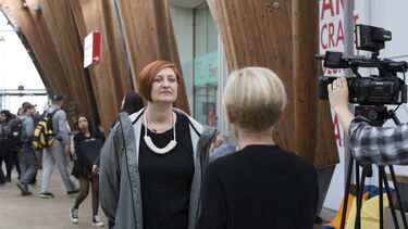 Image of woman being interviewed by film crew in Sheffield's Winter Gardens