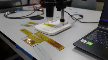 Lots of 3D-printed radio antennas on a desk next to a laptop