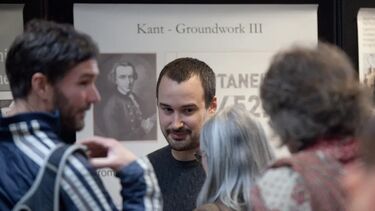 A group discussing a historical exhibit at a festival