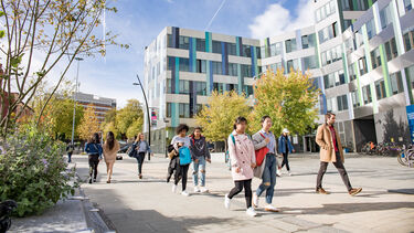 People walking past the Jessop West building on the University of Sheffield's campus 