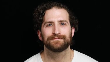 Mauricio Pena wearing a white T-shirt.