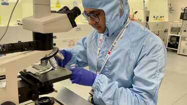 Photograph of PhD student(Tarick Blain) performing optical inspection of newly fabricated GaAsSb/AlGaAsSb Separate Absorption and Multiplication Avalanche Photodiode.