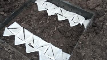 A photo showing bags of crushed basalt to be buried in the soil, as part of the RockFACE enhanced rock weathering trials for greenhouse gas removal at elevated CO2 levels