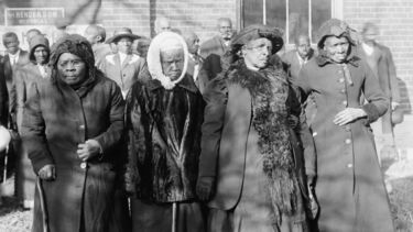 A black and white photo of four women from the Antebellum South
