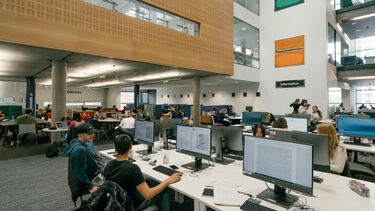 The interior of the Inormation Commons, with desks and computers spread across the space