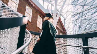 William Zheng in graduation gown in the Heartspace
