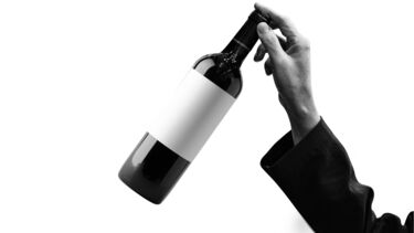 hand picking up bottle of wine