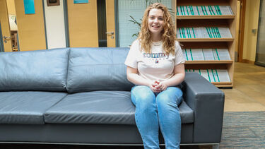 Evie Gruszyk sat on a leather sofa inside in the SITraN building