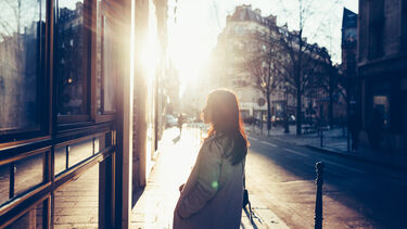 A woman looking through a shop window in Paris